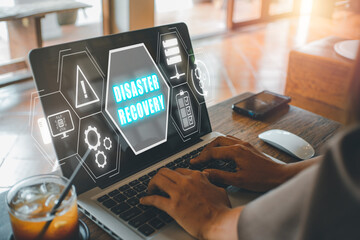 Disaster Recovery concept, Person hand using laptop computer with Disaster Recovery icon on virtual screen.