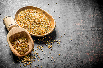 Poster - Dijon mustard in a wooden plate and scoop.