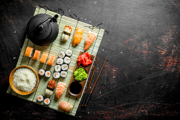 Poster - Set of Japanese sushi rolls with sauce and chopsticks.