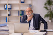 © Elnur - Old male employee after accident sitting at workplace