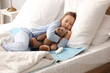 © Pixel-Shot - Little girl with toy sleeping on electric heating pad in bedroom