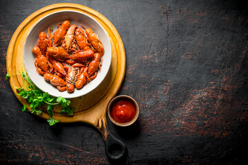 Poster - Boiled crayfish in a bowl on a cutting Board with parsley and sauce.