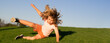 Kid runs through the spring grass and falling down. Moment of the fall down. Little child tripped and falls down. The moment of the fall. Spring and kid. Wide photo banner for website header.