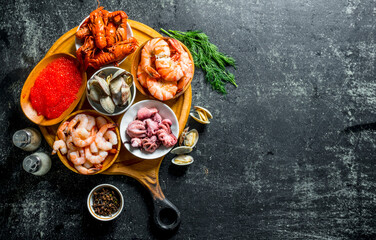 Poster - Various seafood on a round cutting Board with herbs and spices.