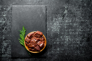 Sticker - Pieces of raw liver on a plate of dill.