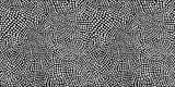 Seamless hand drawn small dense polkadot animal spots pattern in white on black background. Abstract aboriginal dot art motif or organic cellular texture in a trendy doodle line art or linocut style.