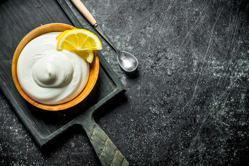 Wall Mural - Mayonnaise on a cutting Board with lemon slices.