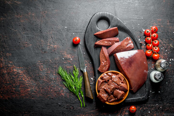 Poster - Raw liver with cherry tomatoes, spices and dill on a cutting Board.