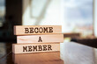 Wooden blocks with words 'BECOME A MEMBER'.