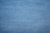 Fototapeta  - Blue jeans fabric background texture. Blue jeans fabric cloth textile material.