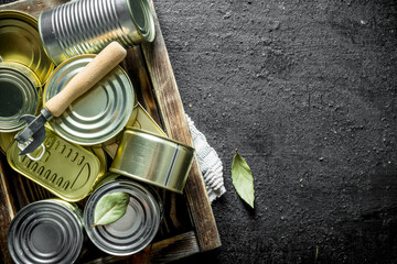 Wall Mural - Assortment of closed tin cans with canned food on the tray.