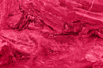stone background texture. viva magenta color of the year 2023.