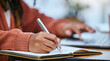 © Delcio/peopleimages.com - Student, writing and hand with notebook for studying, learning and creative notes for academic class. University, college and zoom of hands with pen to write schedule information, planning and ideas