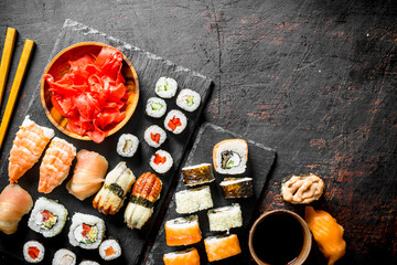 Canvas Print - Fresh sushi rolls on black stone stand.