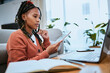 © Delcio/peopleimages.com - Black woman, tablet and student reading on laptop for online email communication and planning college schedule in home office. African girl, thinking and digital tech devices for elearning education