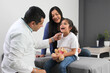 © Arlette - Latina mother cares for and accompanies her curly little daughter at the dark-haired pediatrician specialist doctor's office to prevent abuse and harassment at her medical checkup