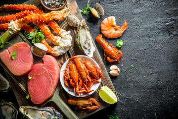 Wall Mural - Fresh tuna steak on a cutting Board with seafood.