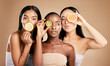 © J Maas/peopleimages.com - Skincare, diversity and women with fruit, cosmetics and dermatology with friends on brown studio background. Face, vitamin c or ladies with natural beauty, girls and nutrition with healthy lifestyle
