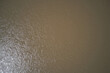 Texture green brown river top view. Brown river view from above. Texture dirty water top.