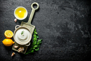 Sticker - Mayonnaise on a cutting Board with lemon and parsley.