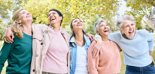 Wall Mural - Senior people, laughing and bonding in comic joke or funny meme in nature park, spring garden or relax environment. Smile, happy women or diversity elderly friends with comedy in retirement support