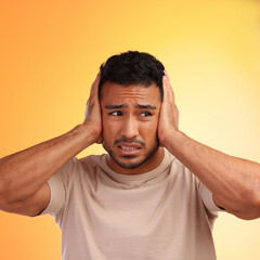 Sticker - Scared, loud and man worried by his stress and covering his ears in fear of noise isolated against a studio orange background. Young, hispanic or guy frustrated by sound causing head pain or ache