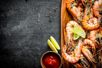 Wall Mural - Fried shrimps on a plate with sauce and lime.