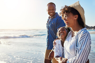 family, travel and walking on a beach with adorable child on vacation or holiday at the ocean or sea