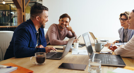 Wall Mural - Advertising professionals having a meeting in a boardroom