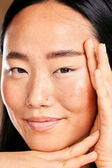 Wall Mural - Closeup portrait, hand frame and asian woman in studio with skincare, natural skin glow and smile. Happy japanese model, cosmetic beauty and healthy aesthetic with self care, wellness and headshot