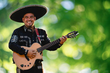 Mexican Musician Mariachi With Guitar On A Blurred Green Background