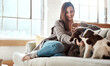 Woman with smartphone, relax with puppy and content at home, happy together and care for pet in living room. Happy woman with dog, scroll social media and love for animals with smile and happiness