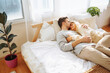 © maxbelchenko - Young beautiful couple embracing in bed in the morning. Romantic day together.