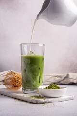 Canvas Print - Organic green matcha ice tea or latte in trendy glass with bamboo whisk