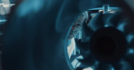 Fototapete - Thrust Engine Engineer Working on a Project with Futuristic Turbine Motor, Standing with Laptop Computer in Scientific Technology Lab. Science Professor Developing a Futuristic Engine