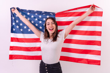 caucasian woman smiling with usa flag isolated on a white background