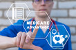 Doctor using virtual touchscreen presses inscription: MEDICARE ADVANTAGE. Concept of medicare advantage. Health care insurance plan. Medicare benefits.