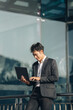 © PaeGAG - Handsome young manager working on laptop while sitting outdoors on the stairs, concept of work life balance.