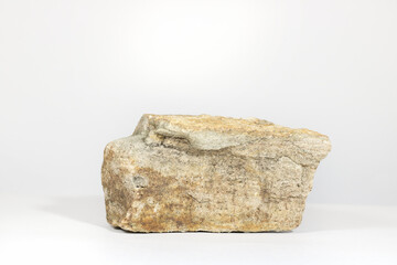 Wall Mural - podium pedestal made of natural sand stone isolated on white background with hard shadows. minimal e