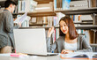 © Garun Studios - High school or college students studying and reading together in library. Student use laptop at library.Education, Learning, Student, Campus, University, Lifestyle concept.