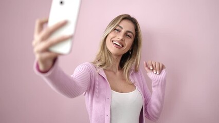 Sticker - Young blonde woman smiling confident making selfie by smartphone over isolated pink background