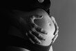 © Tunatura - Beautiful body of pregnant young woman with fathers hands touching the belly.