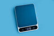 Electronic kitchen scales on a colored background