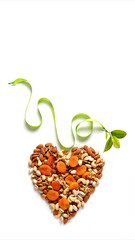 Wall Mural - Almond nuts, laid out in the shape of a heart on white background . Concept of the Jewish holiday Tu Bishvat. Copy space