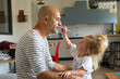 © Giulio_Fornasar - father gets his daughter to do his make-up with his eyes closed
