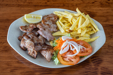 Wall Mural - A traditional Portuguese dish of roasted black pig meat and fried potatoes. Secretos