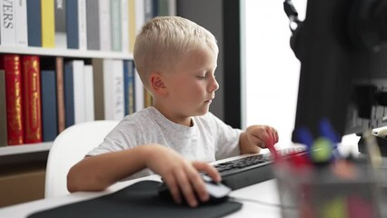 Poster - Adorable toddler student using computer sitting on table at classroom