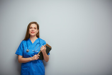 Wall Mural - Smiling student woman with medical education holding book. Isolated portrait with copy space.