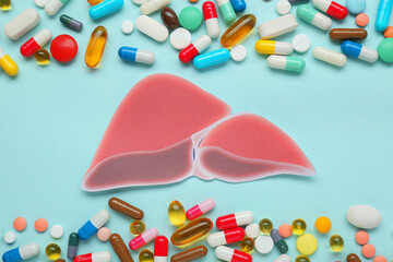 Poster - Paper liver and pills on turquoise background, flat lay. Hepatitis treatment