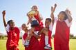 © Nina/peopleimages.com - Soccer, team and trophy with children in celebration together as a girl winner group for a sports competition. Football, teamwork and award with soccer player kids celebrating success in sport
